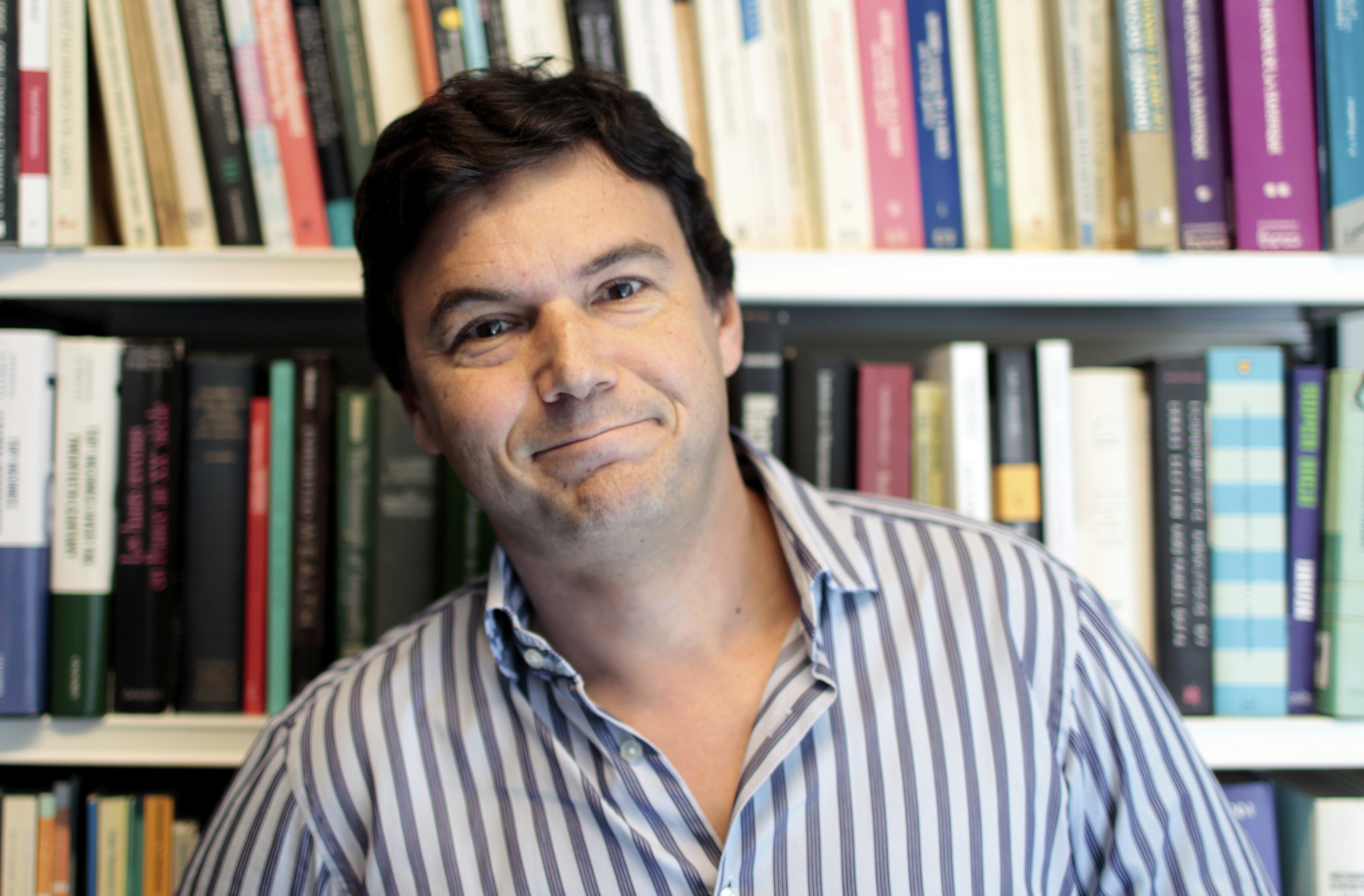 French economist Thomas Piketty poses in his office in Paris
